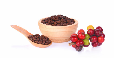 coffee beans in spoon in bowl on white background