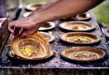 Cooking traditional asian pancakes. Indian and Chinese street food. Food court on local market of Langkawi island, Malaysia. Traditional asian street food.