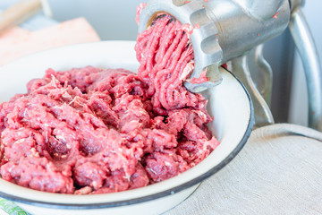 Cooking minced beef in a meat grinder close-up