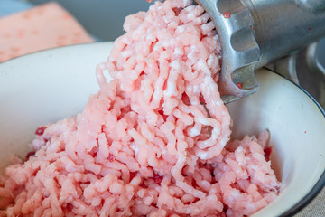 Cooking minced pork in a meat grinder close-up