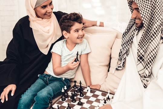 Arabian Boy Playing Chess with Father at Home.