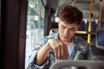 Transport. People in the bus. He reading book in transport. © makistock