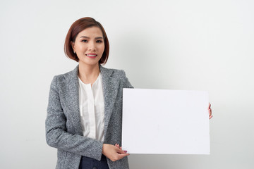 Beautiful asian women hold and show white blank paper advertising on white background