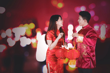 Happy Chinese couple carrying red lantern
