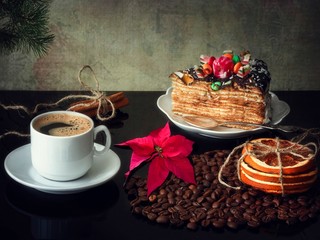 Cup of coffee and cake on Christmas table