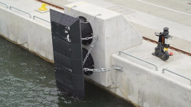 The black metal plate on the side of the port in Stockholm Sweden with the chains on it where the ship docks in