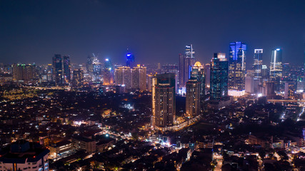 Obraz premium Office buildings with residential house at night