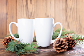 Christmas composition with white cups, Christmas-tree cones and branches of spruce. Template. Concept with copy space.