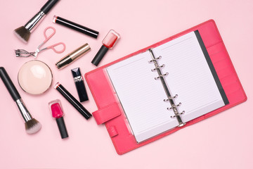 Make up or visage background. Blank page notepad and different cosmetic accessories in the holder with copy space.