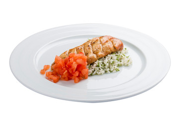 Chicken fillet in sweet and sour sauce with rice and vegetables. On a white background