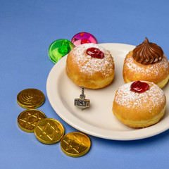 Fresh donuts, chocolate coins and  dreidels   for Hanukkah celebration.