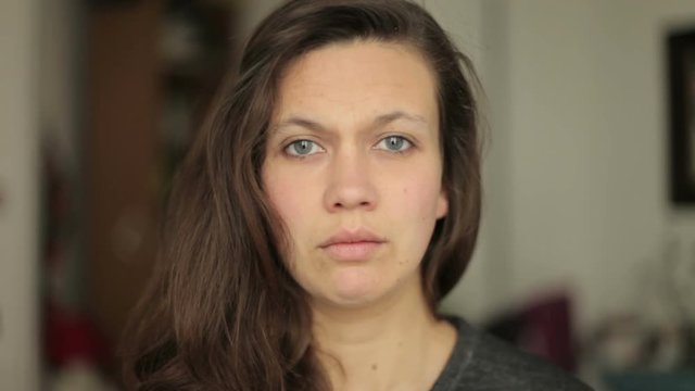 Young woman looking Surprised shocked into camera