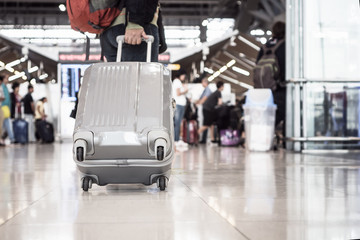 Traveling luggage walking at airport terminal for checkin. Travel and vacation concept