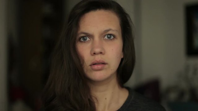 Young woman looking Surprised shocked into camera