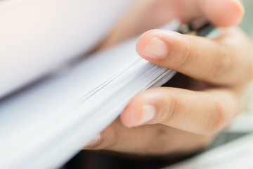 Accounting planning budget concept : Business woman offices working for arranging documents unfinished stack of document papers with pen, clip papers on busy office desk