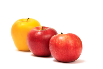 Row of ripe apples on a white background