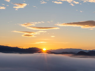 Sunrise with early morning sky scene covered in foggy