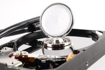 RECOVERY AND REPAIR TECHNOLOGY CONCEPT: Hard Disk Drive (HDD) with stethoscope isolated on white.