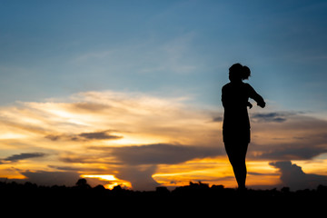 young woman warming up outdoors at park