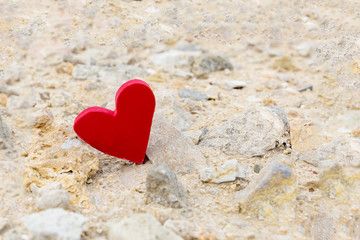Fototapeta premium Red heart on a background of stones.