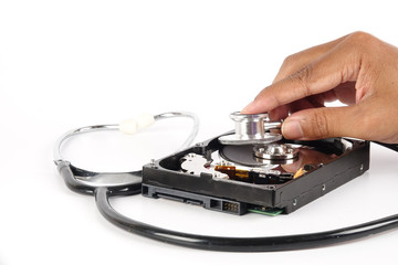RECOVERY AND REPAIR TECHNOLOGY CONCEPT: Hard Disk Drive (HDD) with stethoscope isolated on white.