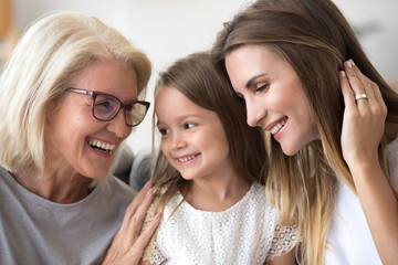 Smiling loving three generation of women concept laughing, grandmother, daughter and child girl...