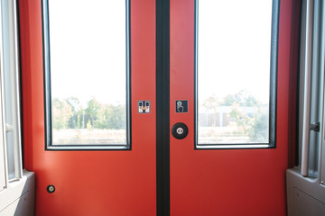 The exit door of the train with a button to automatically open the door on demand when the train stops.