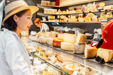 Woman customer at the Cheese store at the organic market