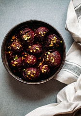 Baked whole beet with olive oil, herbs and pistachios