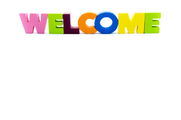 Word WELCOME written with colourful wooden letters, isolated over white with copy space on the bottom