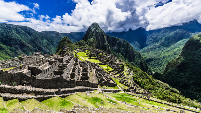 Green mountains surround the ruins of the Incas