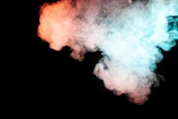 Background of colored smoke of turquoise, green and red color, soaring at the top in the form of a mystical figure resembling a man on a black isolated background. Abstract pattern of steam.