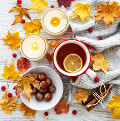 Naklejka na ściany i meble autumn flat lay with cup of tea and leaves