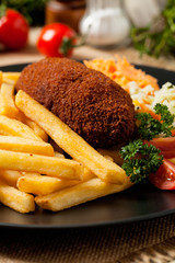 Chicken Kiev (de Volaille chop) with french fries and salads.