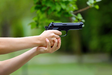 Young boy practice shooting guns on outdoor