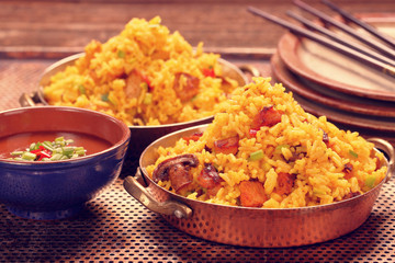 Chicken with basmati rice fried in stainless pan