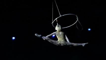 Young girl performs the acrobatic elements in the air ring