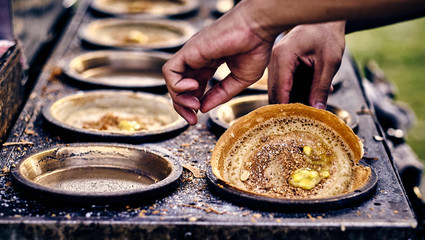 Cooking traditional asian pancakes. Indian and Chinese street food. Food court on local market of Langkawi island, Malaysia. Traditional asian street food.