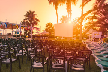 Cinema screen at tropical resort hotel at sunset