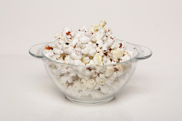 Popcorn in a transparent plate  isolated on white background