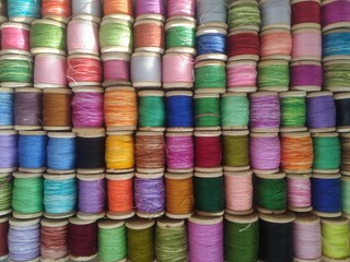 spools of colored thread. multicolored motley background