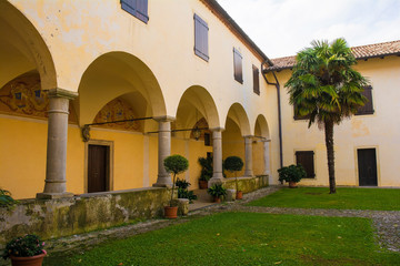 Fototapeta na wymiar The courtyard of Abbazia di Rosazzo - Rosazzo Abbey - which dates back to around 1070 and is located in Friuli, north east Italy. 