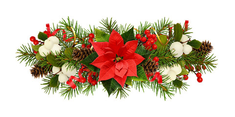 Twigs of Christmas tree, poinsettia flower, berries and holiday decorations in arrangement
