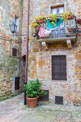 Fototapeta na wymiar Italian backyard with a potted plant and a balcony
