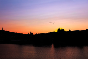 Fototapeta na wymiar Prague, Bohemia, Czech Republic. Sunset glow view of the Prague castle in twilight and silhouette.