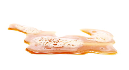 Spilled beer puddle with foam isolated on white background and texture, clipping path