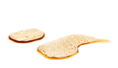 Spilled beer puddle with foam isolated on white background and texture, clipping path