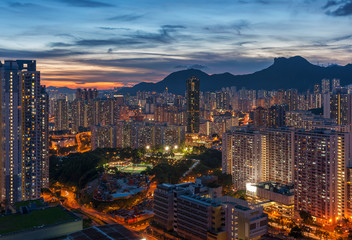 Panorama of Hong Kong City skyline and Lion Rock Hill at dusk