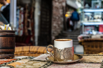 Cup of turkish-style coffe in silver cup-holder at Arasta Bazaar in Istanbul, Turkey