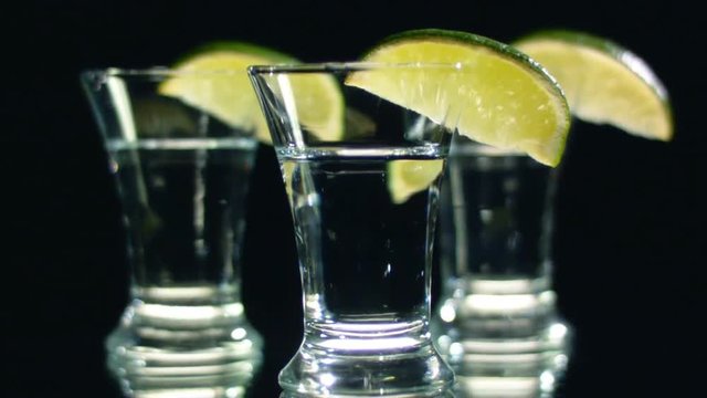 Three glasses of alcohol with lemon